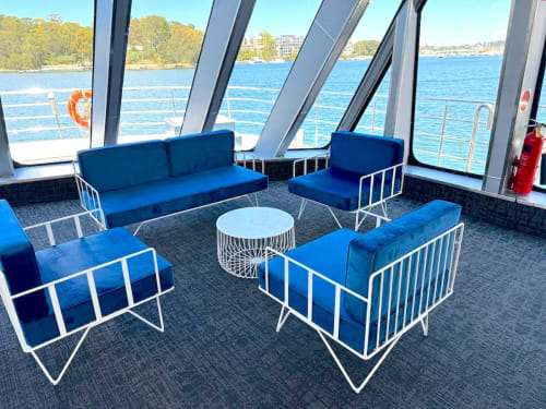 White metal sofa lounge with blue cushions hired for an event on a boat