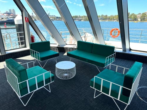 White sofa lounge with green velvet cushions hired for a boating event