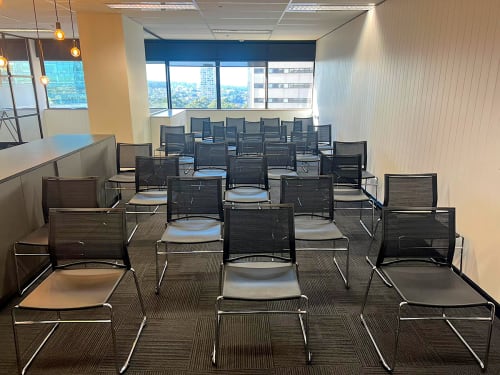 Black plastic conference chairs set up for a meeting
