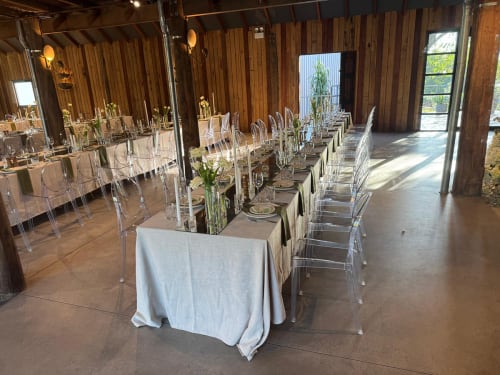 Lots of Victorian ghost chairs set up at a dinner function
