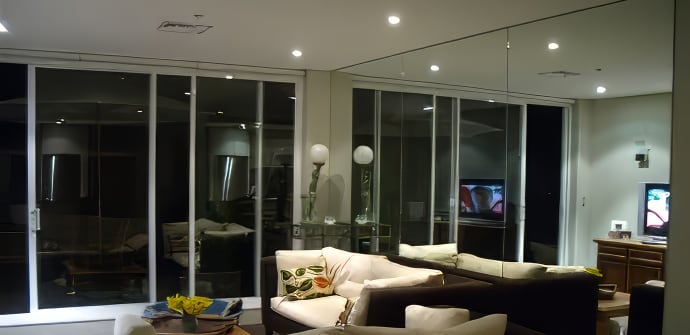 A feature wall mirror in a residential lounge room