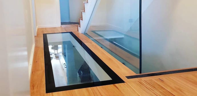 A new glass floor installation next to some stairs