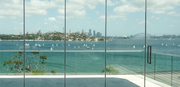 Glass walls with a view of Sydney Harbour