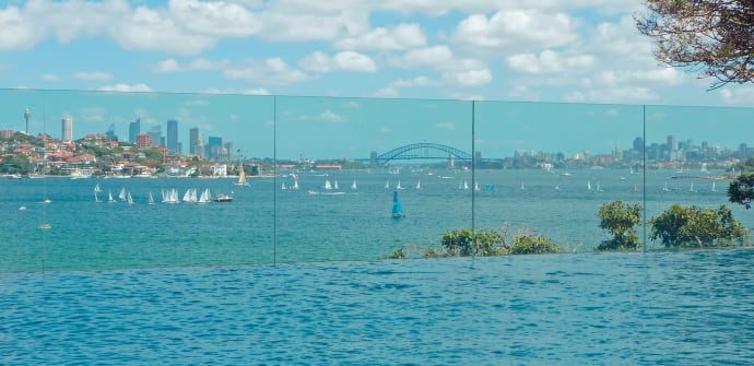 A glass wall with Sydney Harbour as a backdrop