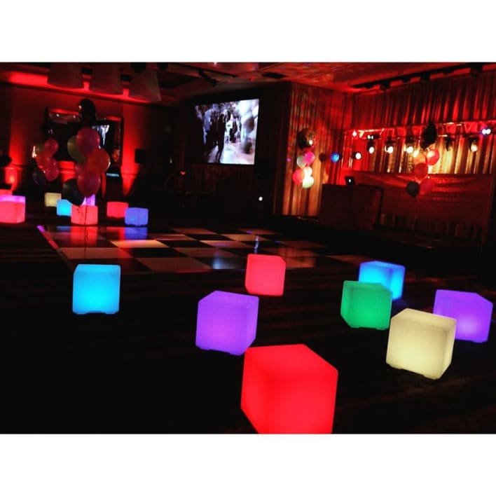 Lighted cubes on a floor in a party.