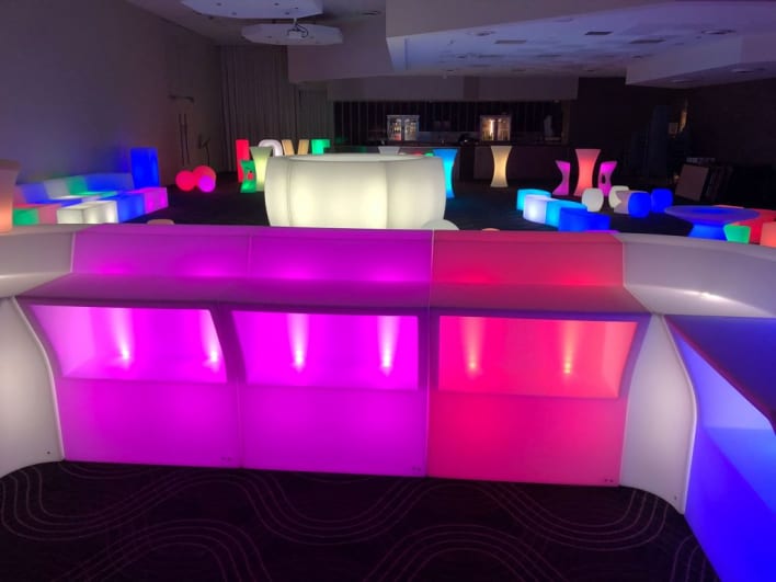 A colorful led bar set up in a room.