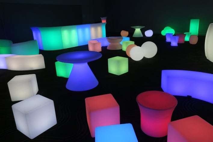 A room full of colorful led cubes and tables.