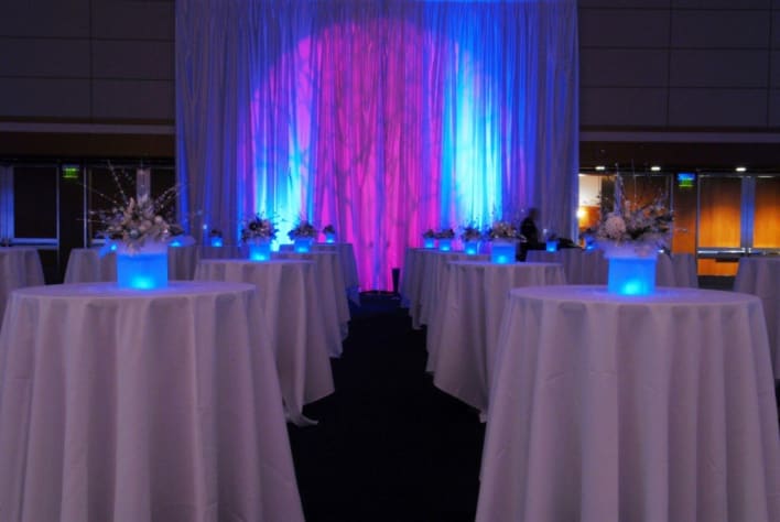 A room with tables and chairs set up for a party.