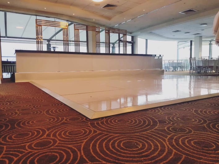 A white dance floor in a large room.