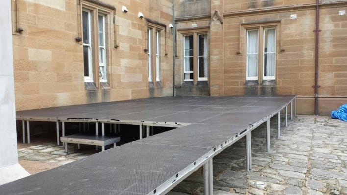 A stage set up in front of a building.