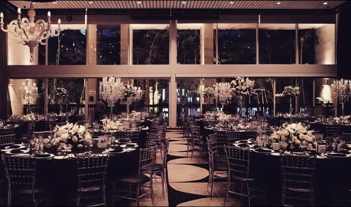 A black and white wedding reception set up in a large room.