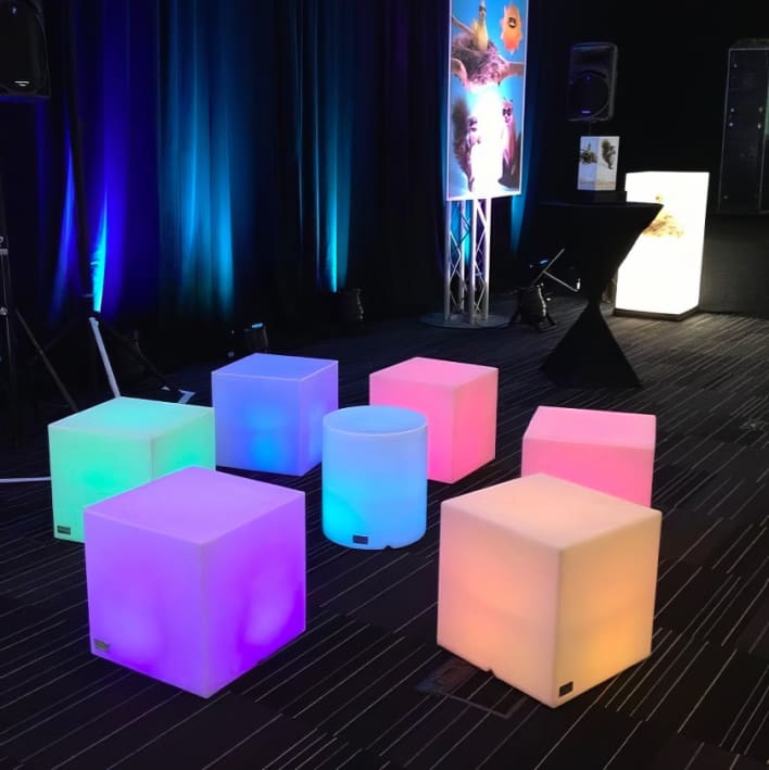 A group of colorful cubes sitting in front of a stage.