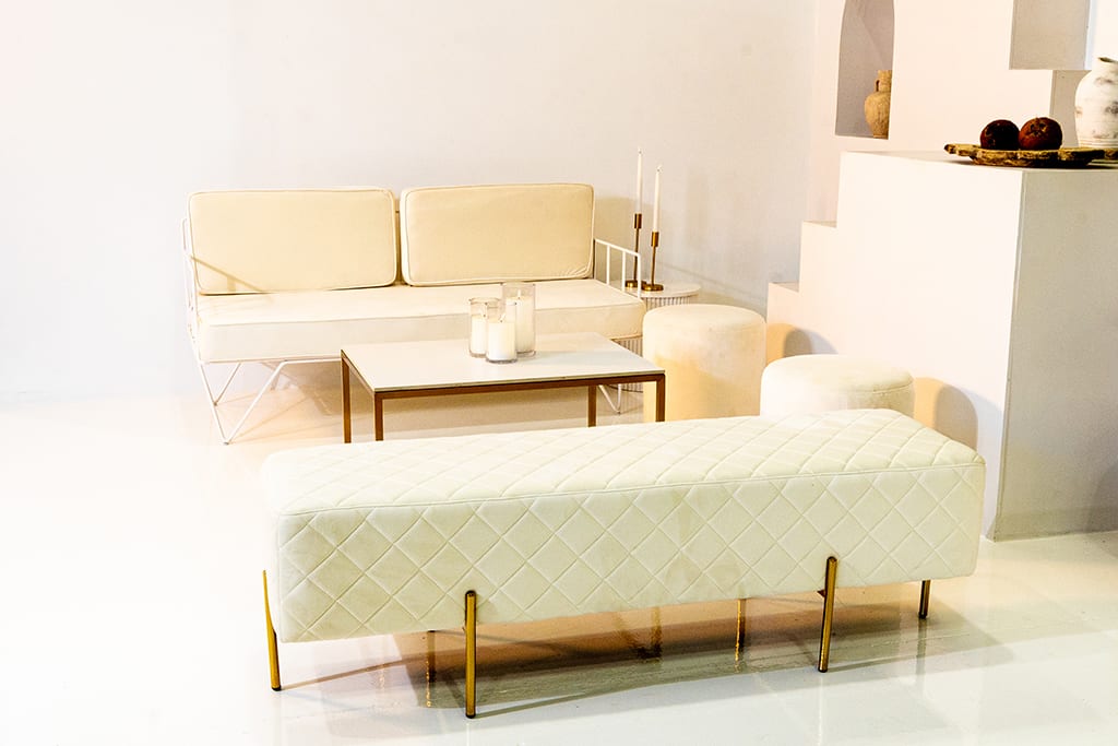 A white wire lounge and white ottoman bench