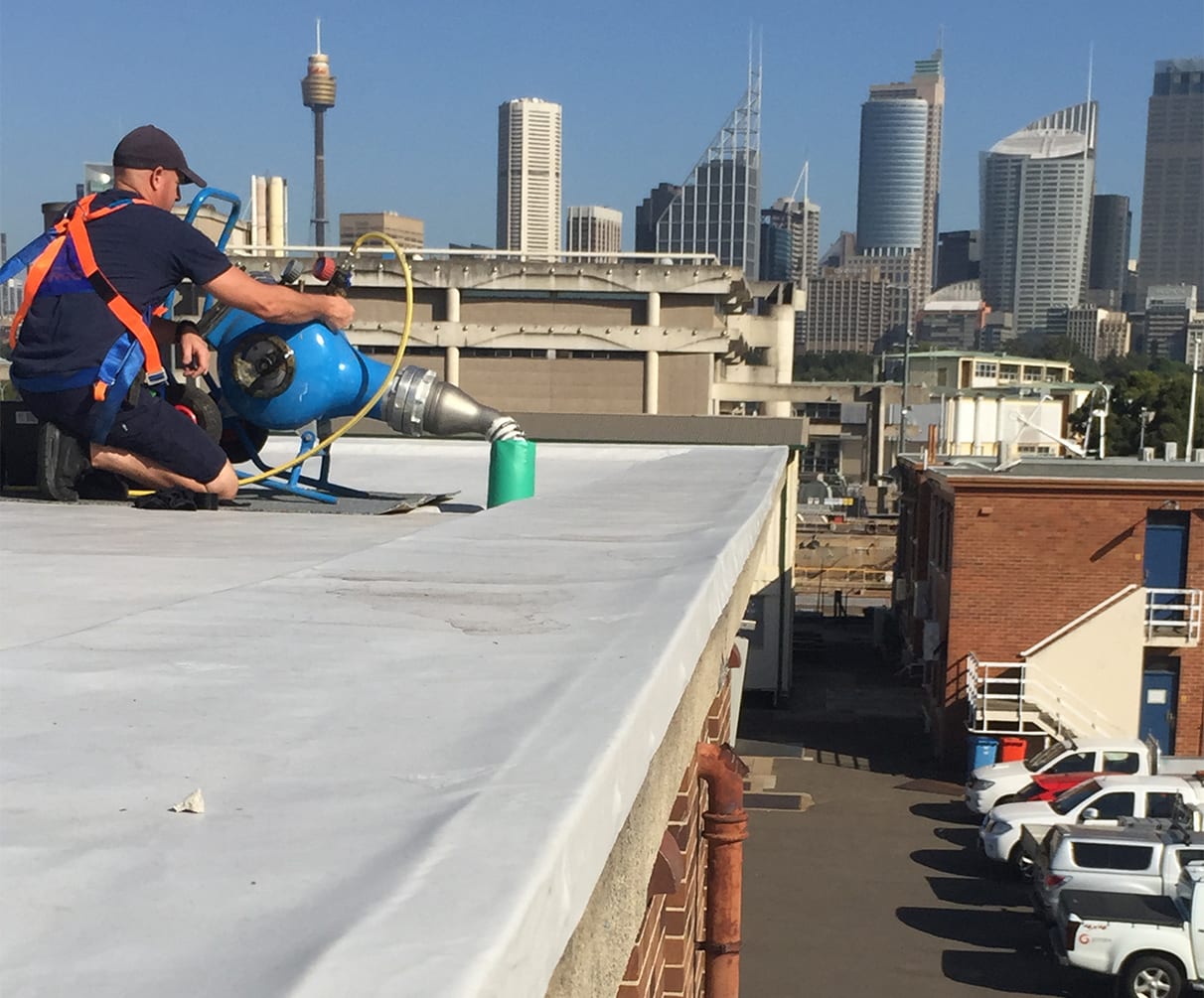 An emergency pipe relining job on a roof in the city