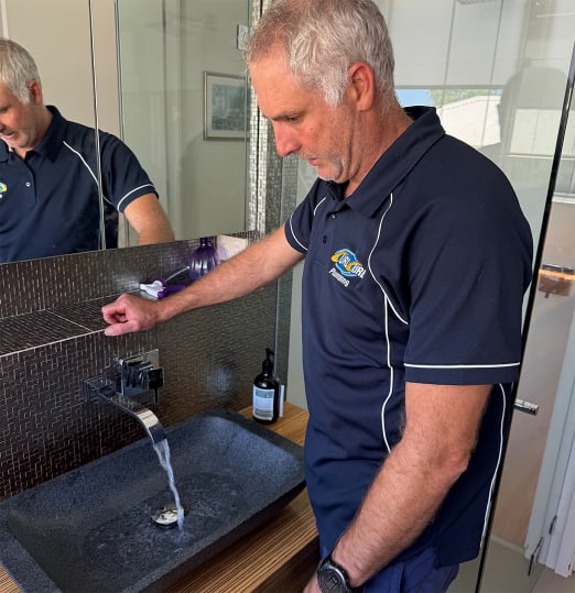 Shane from Curl Curl Plumbing performing some bathroom plumbing