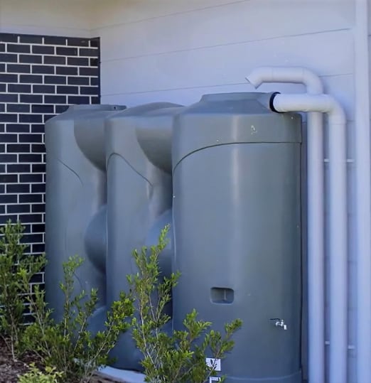 A professional rainwater tank installation on a residential property in Sydney
