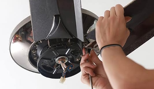 A ceiling fan being repaired