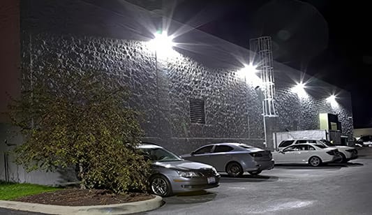 Large wall lights installation in a commercial car park