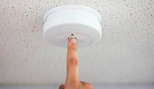 Smoke alarm testing in a commercial building