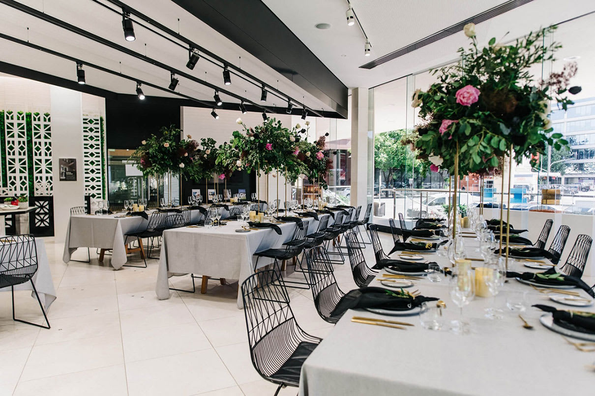 A black table setting in a restaurant.