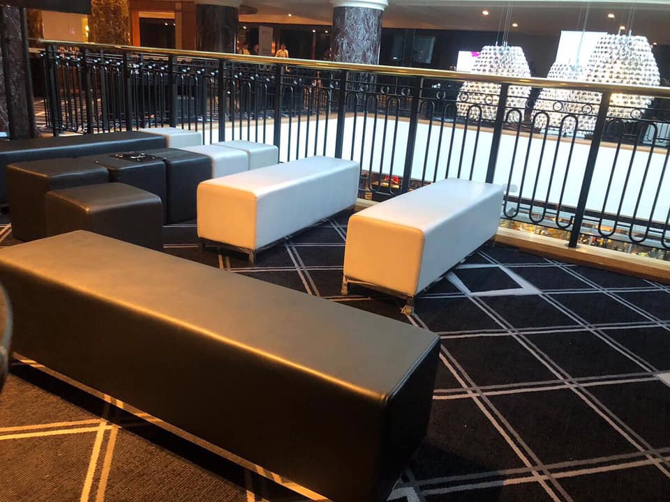 A black seating area in a lobby.