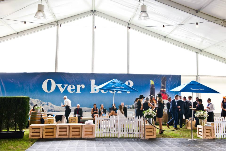 A large tent with people standing in front of it, adorned with a sleek Black Velvet Rope Hire.