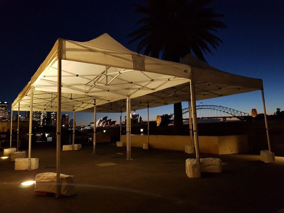 The stunning Sydney harbour bridge and sydney opera house illuminate the night sky, creating a mesmerizing spectacle under the 3mx6m Pop Up Marquee With White Roof.