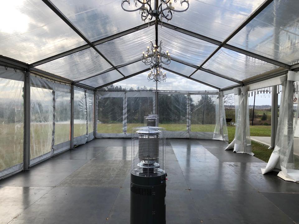 A clear tent with a chandelier in the middle, enhanced with Pkg 7 - 7 x Area Heater Hire w/ Gas Bottles.