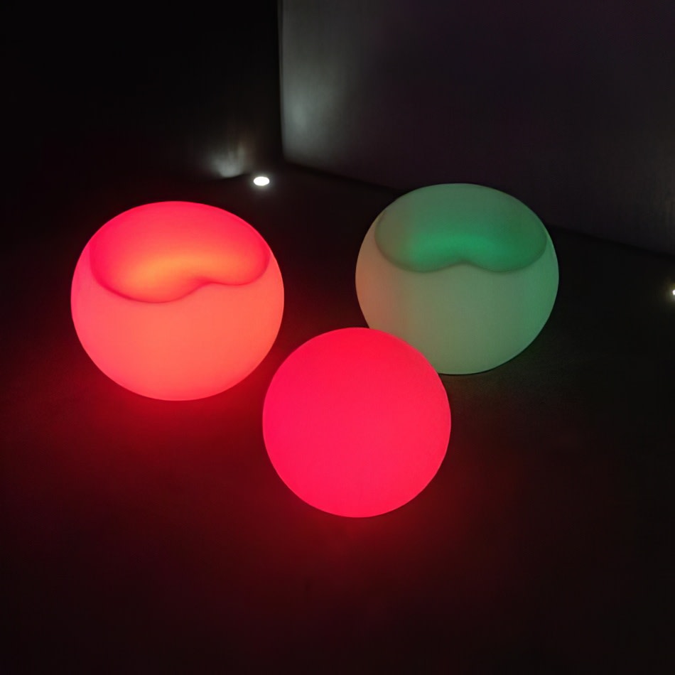 Three lighted spheres sitting on a table.