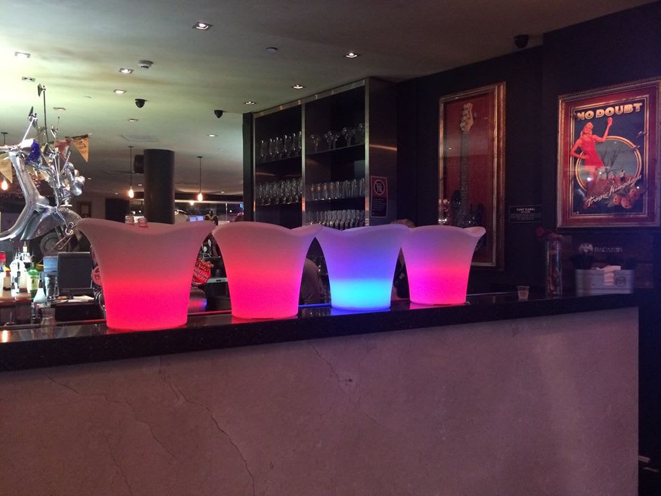 Glowing ice tub hire with three colorful lighted jugs.