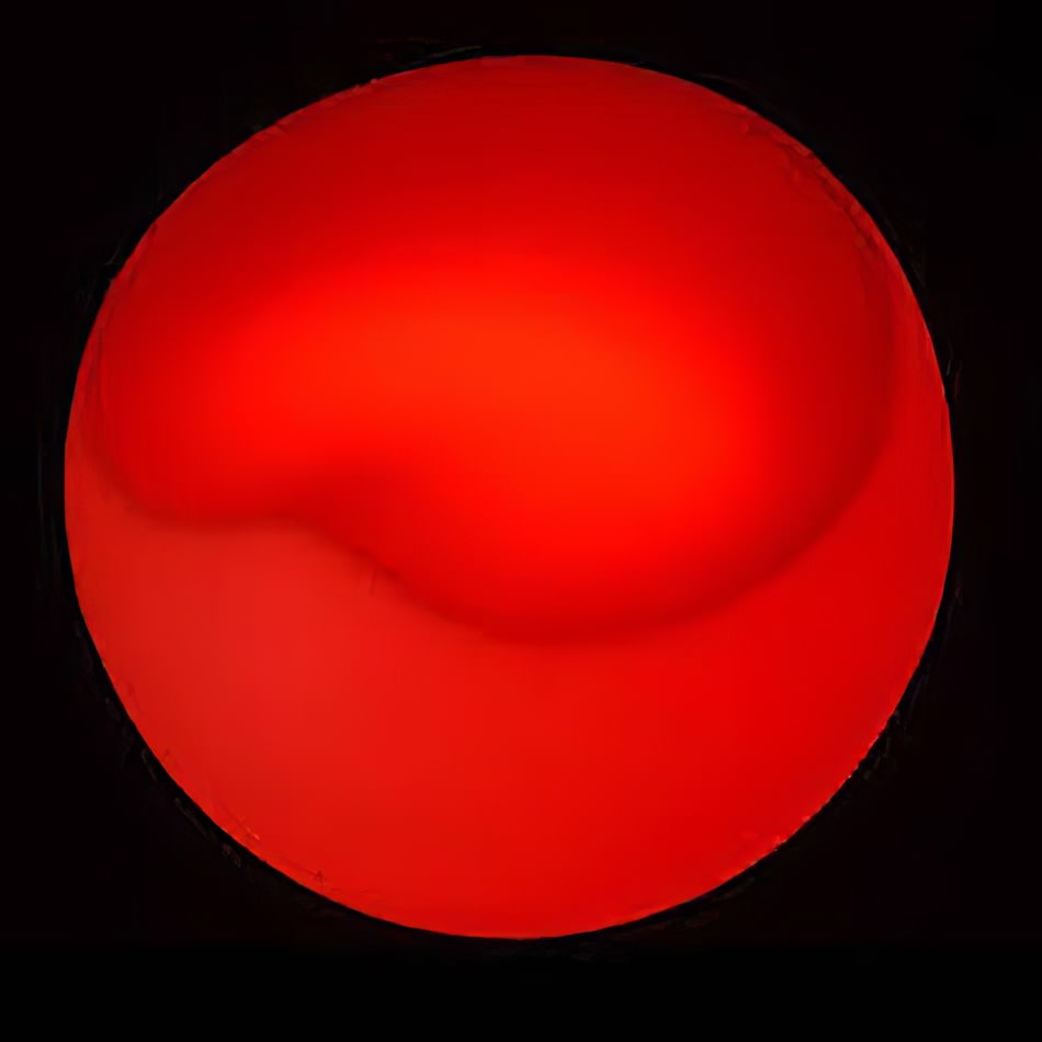 A red sphere sitting on a black background.