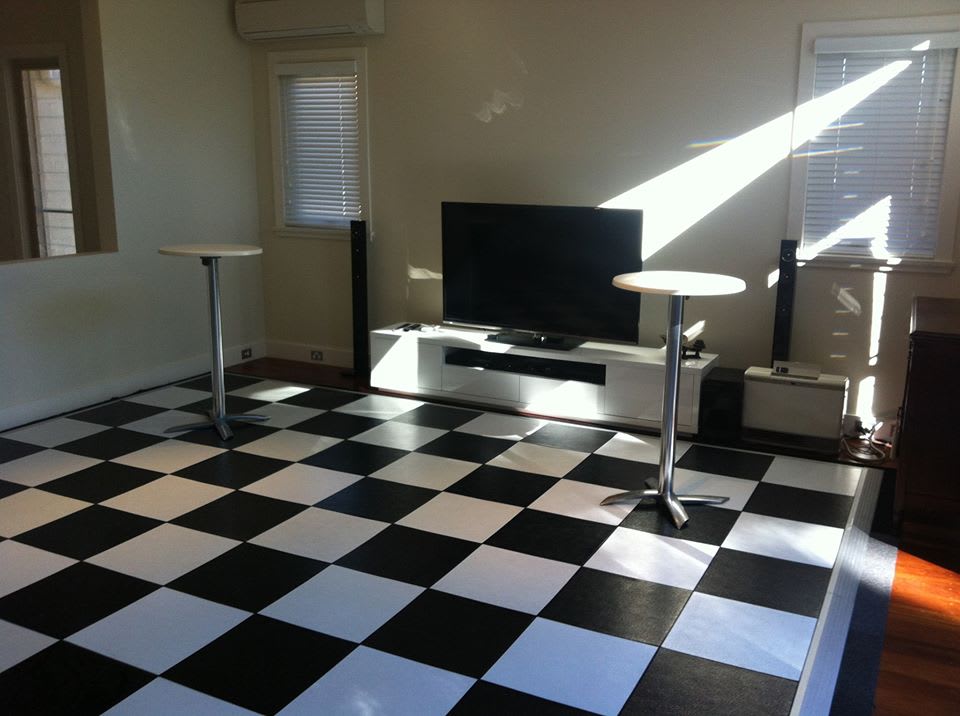 A living room with a black and white checkered floor.