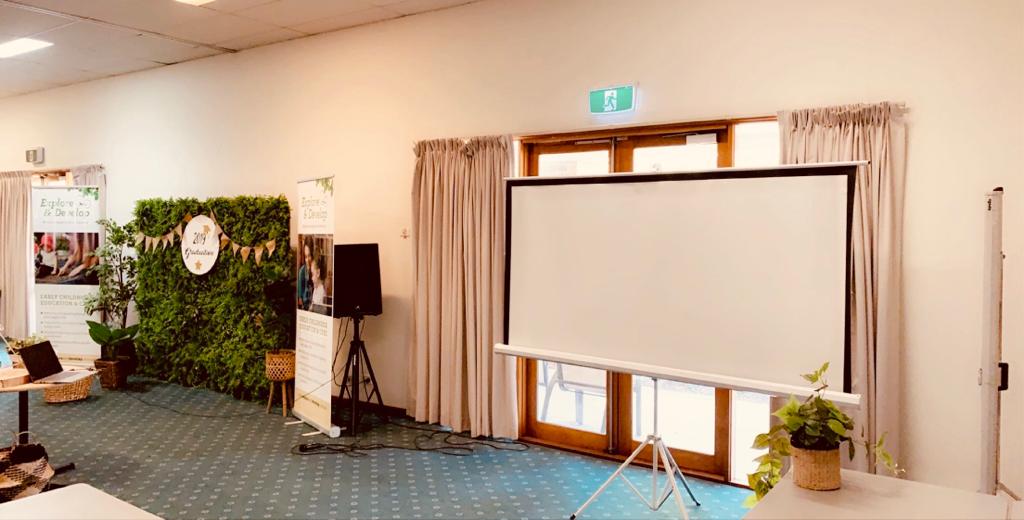 A green room equipped with a projector for hire.