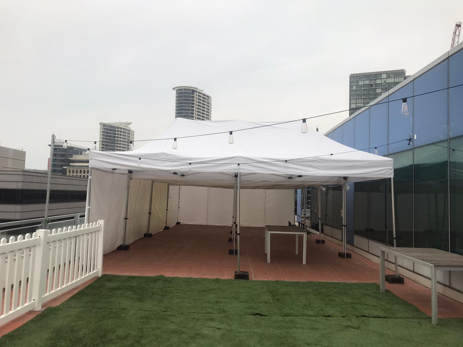 A 4mx8m Pop Up Marquee with walls on 3 sides, set up on the roof of a building.