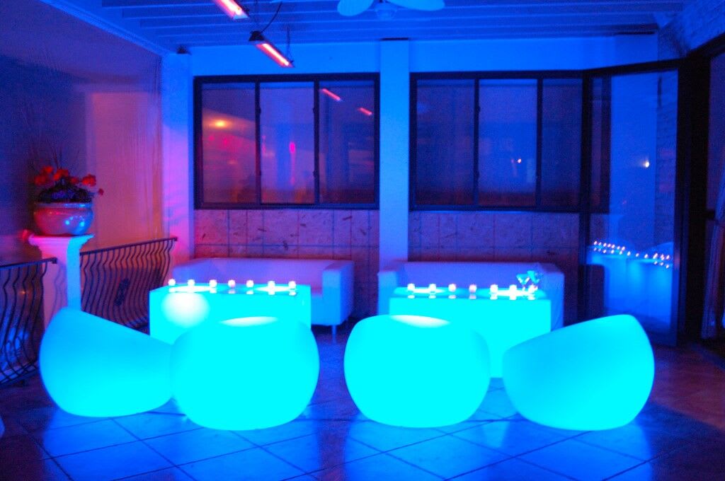 A group of blue Glow Sphere Chairs in a room.