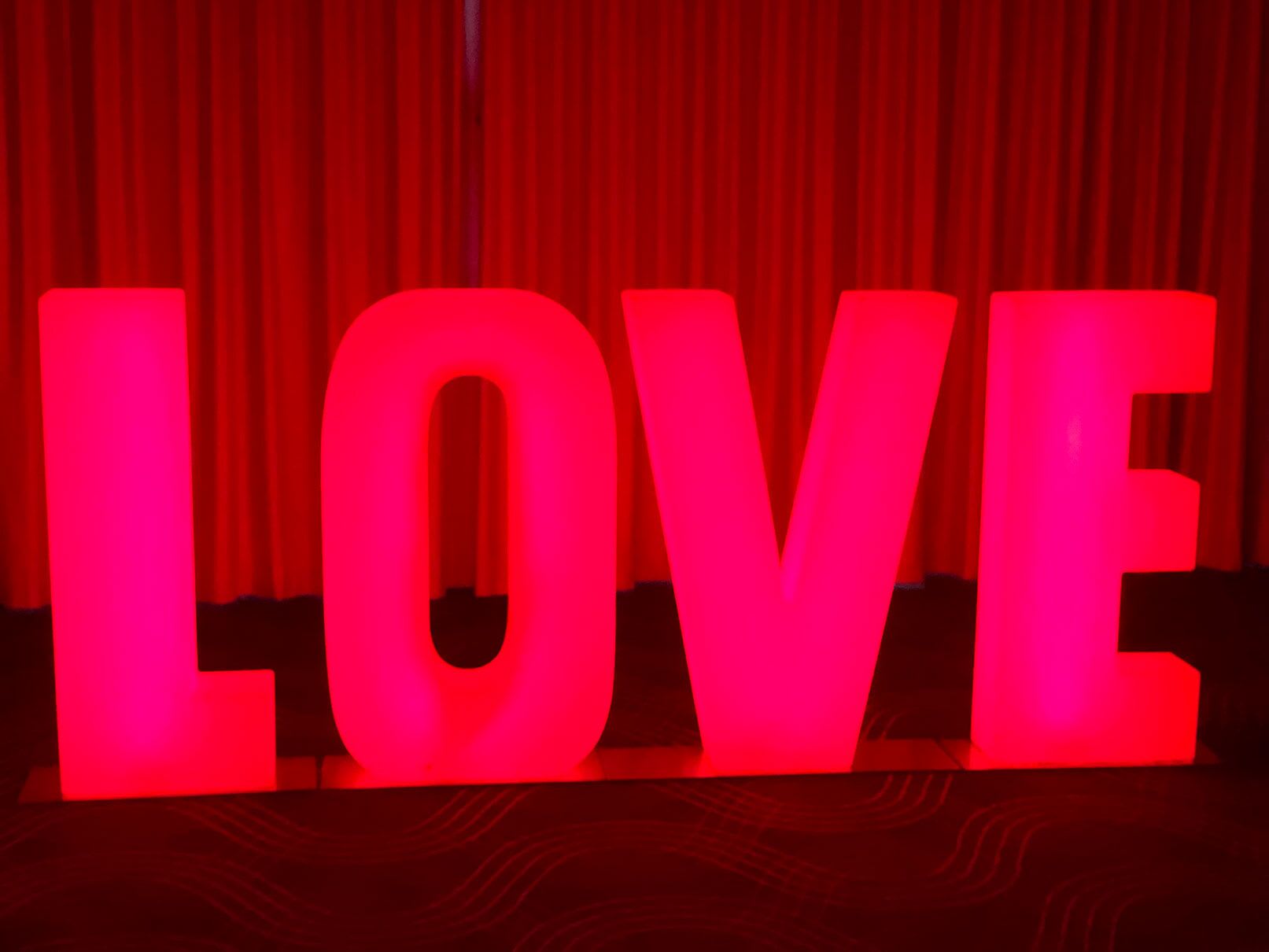 A large red "love" sign with glowing letters.