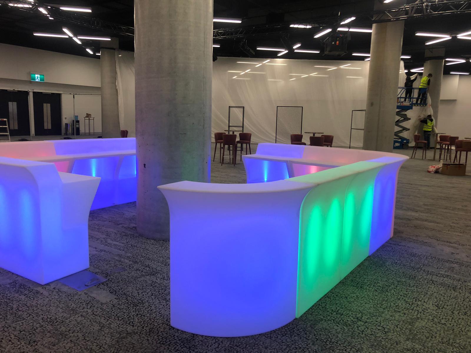 A vibrant glow bar centerpiece in the middle of a room.