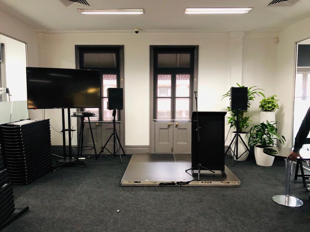 A room with a tv and speakers for an immersive audiovisual experience.