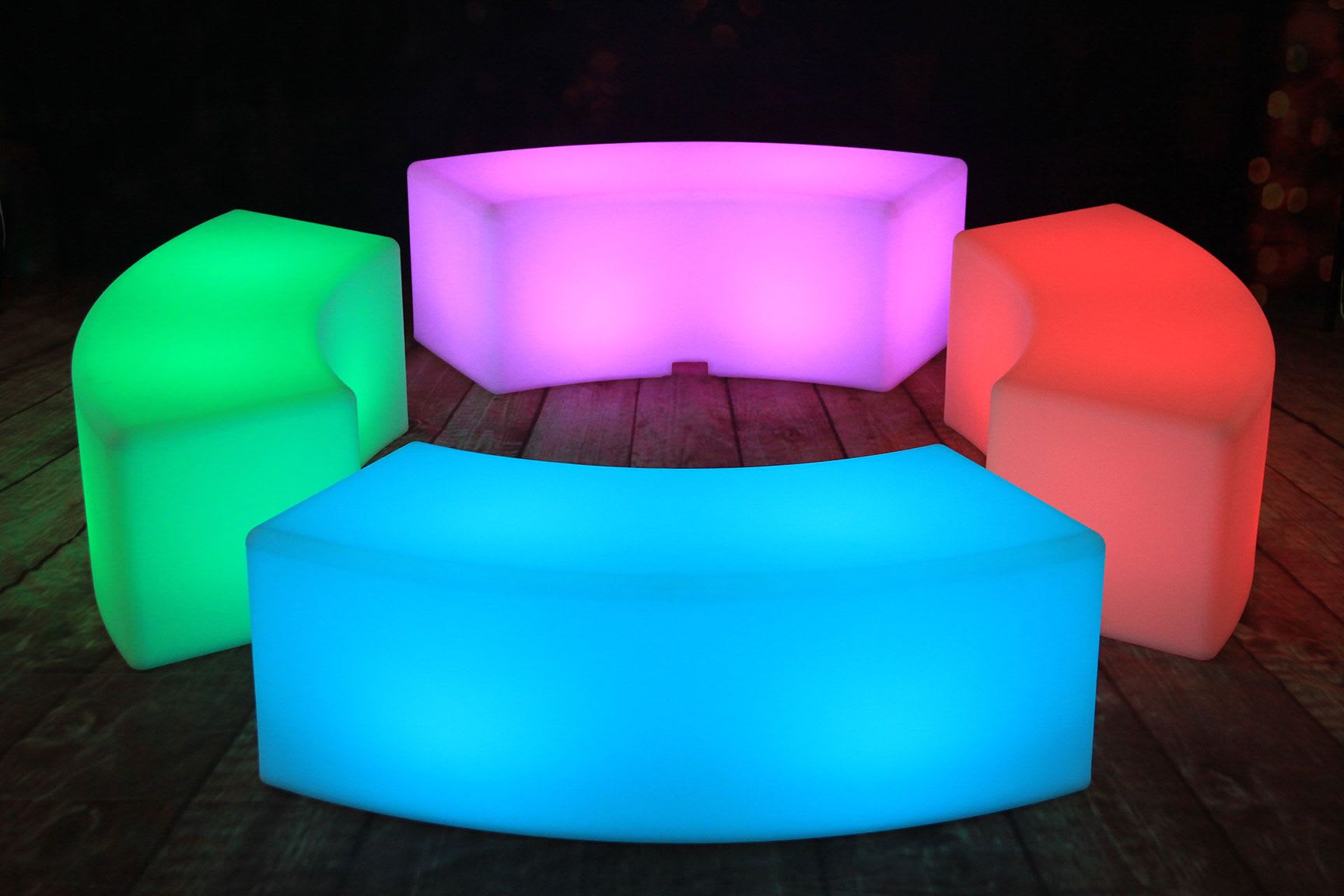 A set of vibrant lighted benches on a wooden floor.