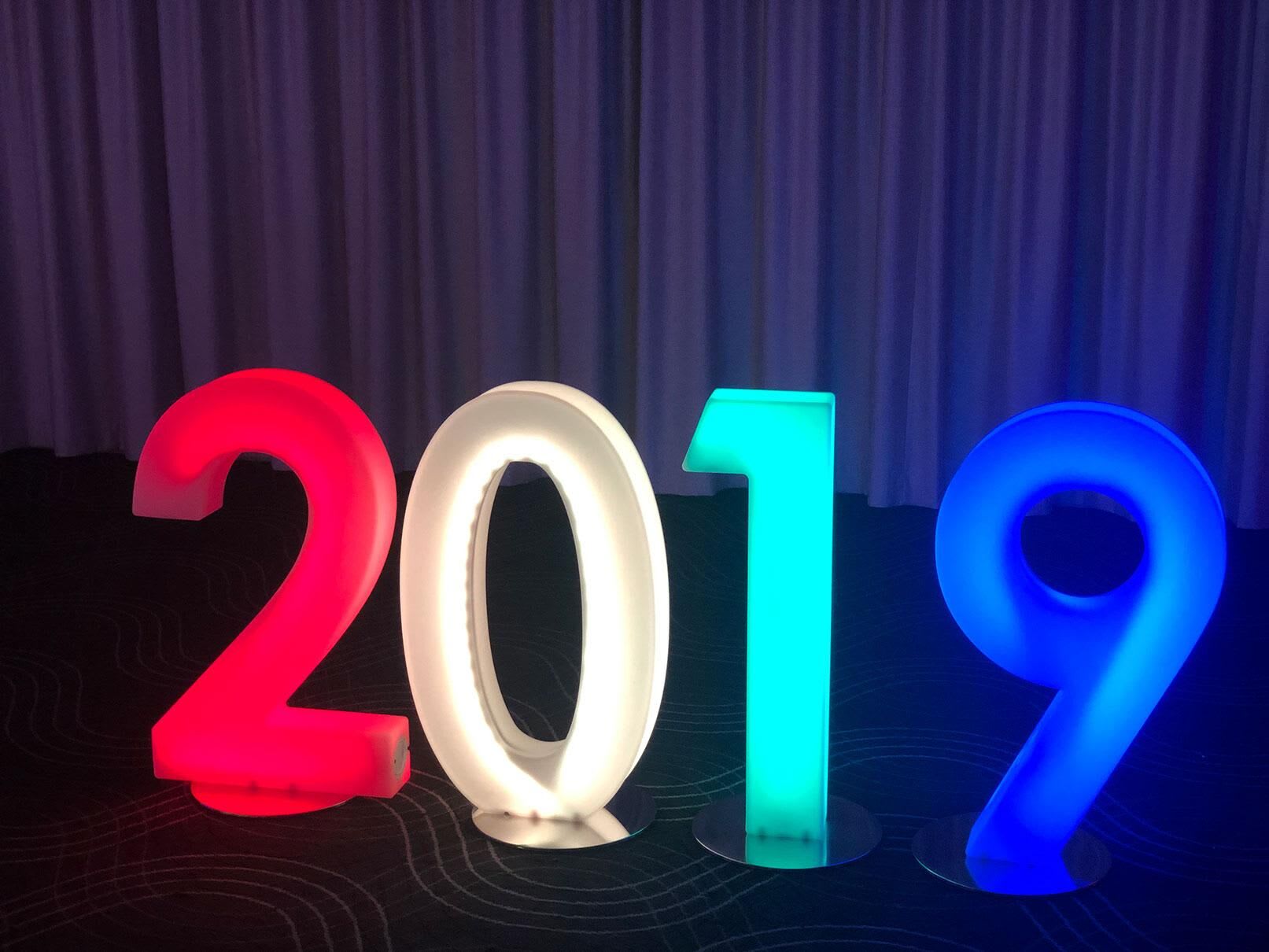 The glowing numbers 2019 are lit up in different colors.