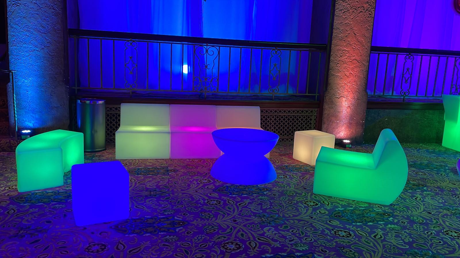 A vibrant assortment of Glow Lounge Suite Hire chairs and tables brighten up the room.