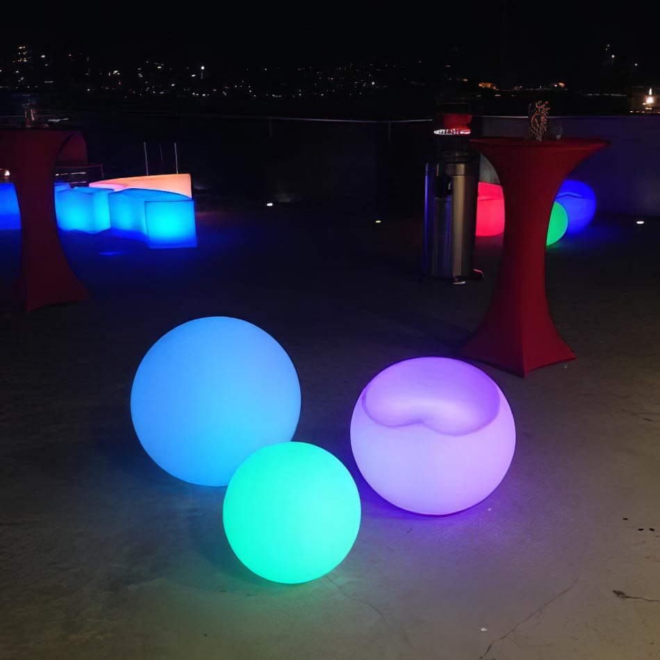 A group of colorful lighted Glow Spheres, measuring 60cm in diameter, placed on a deck.