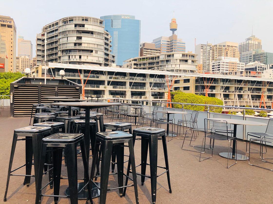 A rooftop bar in Sydney with a view of the city, offering Black Tolix Stool Hire.