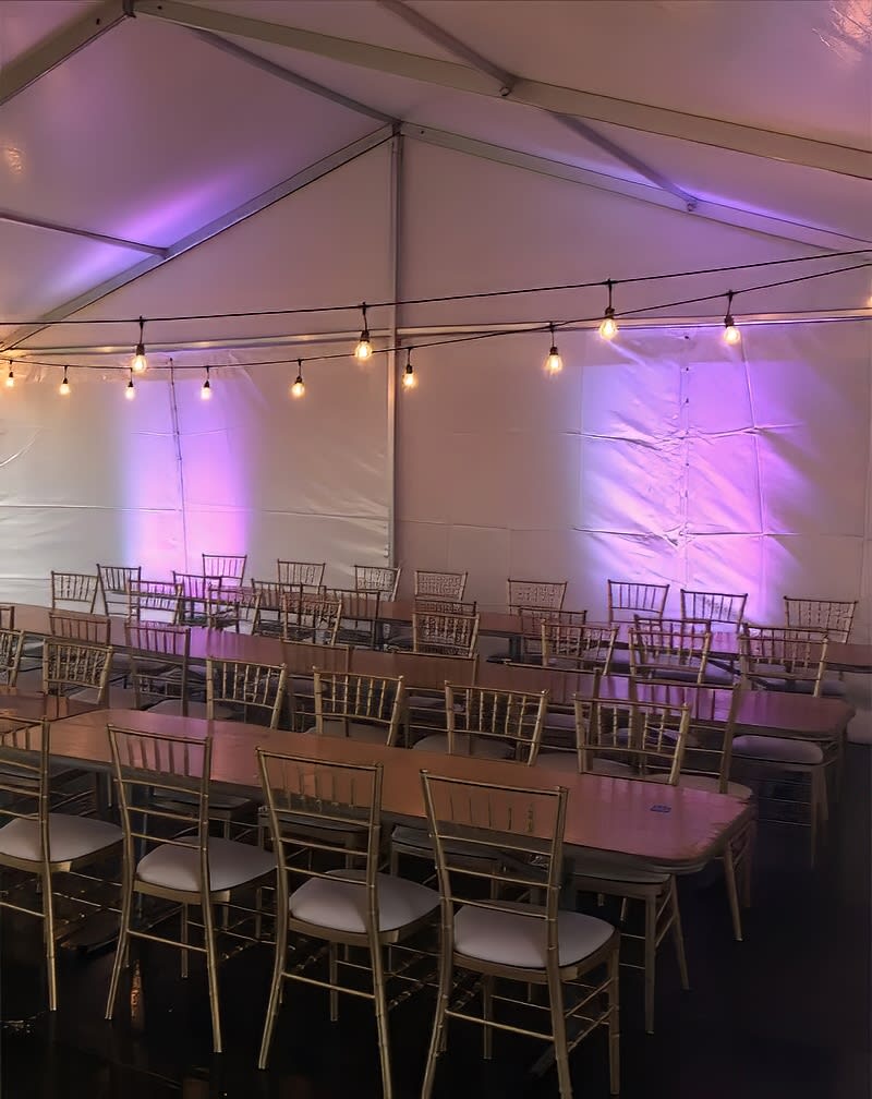 A tent set up with tables and Timber Trestle Table 1.8m Hire.