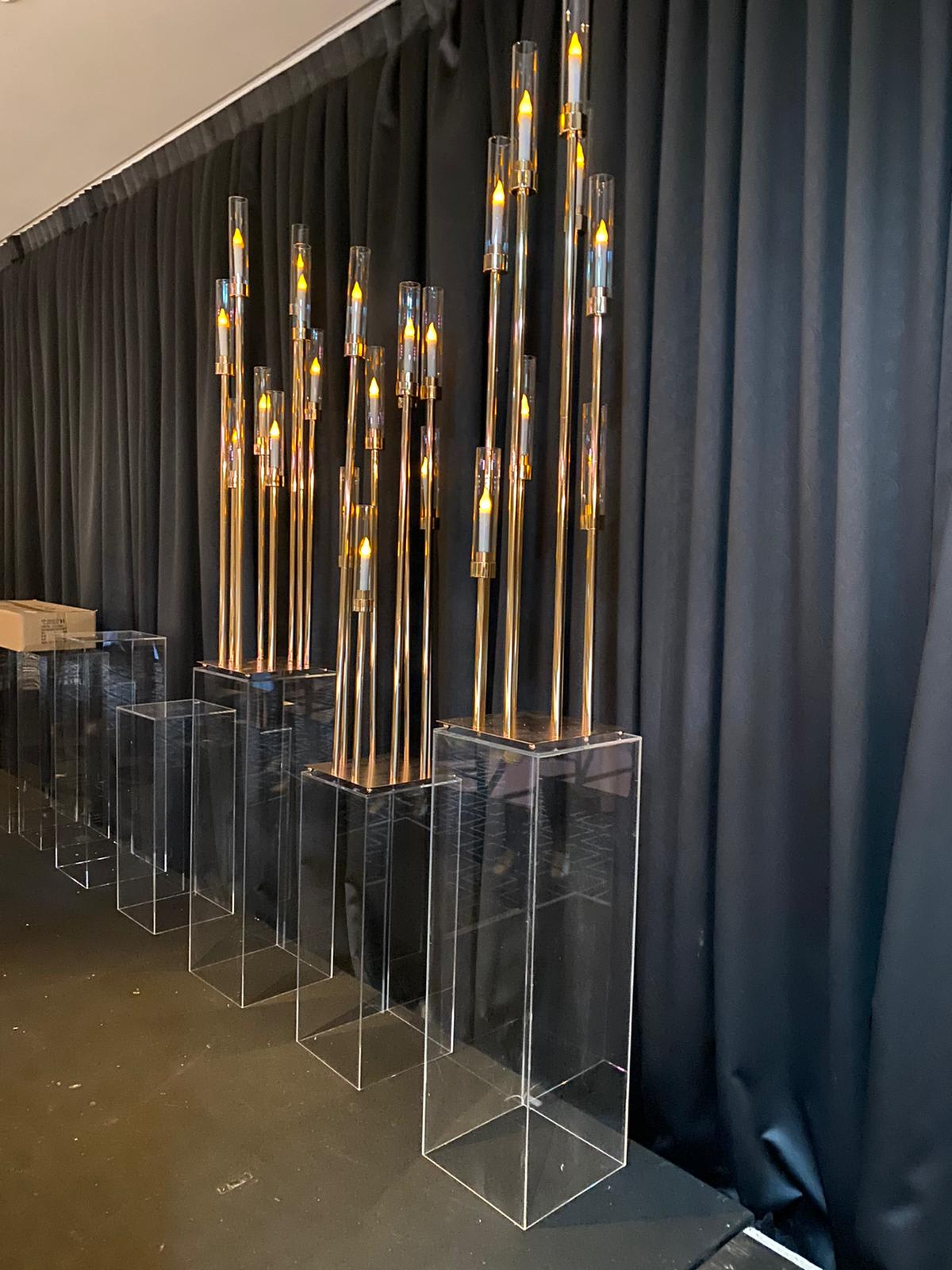 Clear acrylic plinths with candles on them.