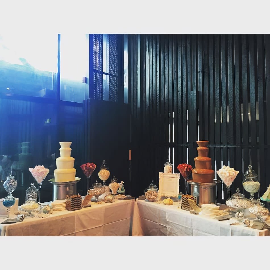 A table with several different types of cakes on it, along with 2 x medium commercial fountains as part of Package 5.