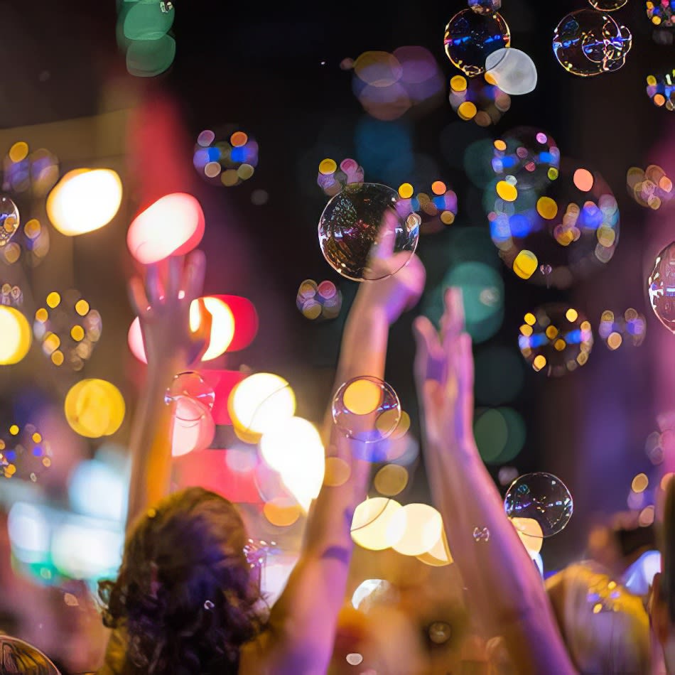 A Bubble Machine Hire group of people with soap bubbles in their hands.