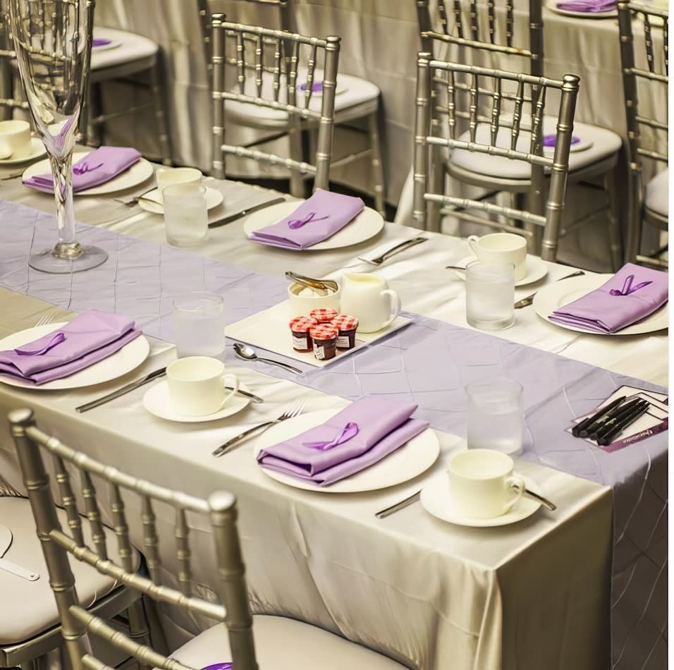 A table set up with silver plates.