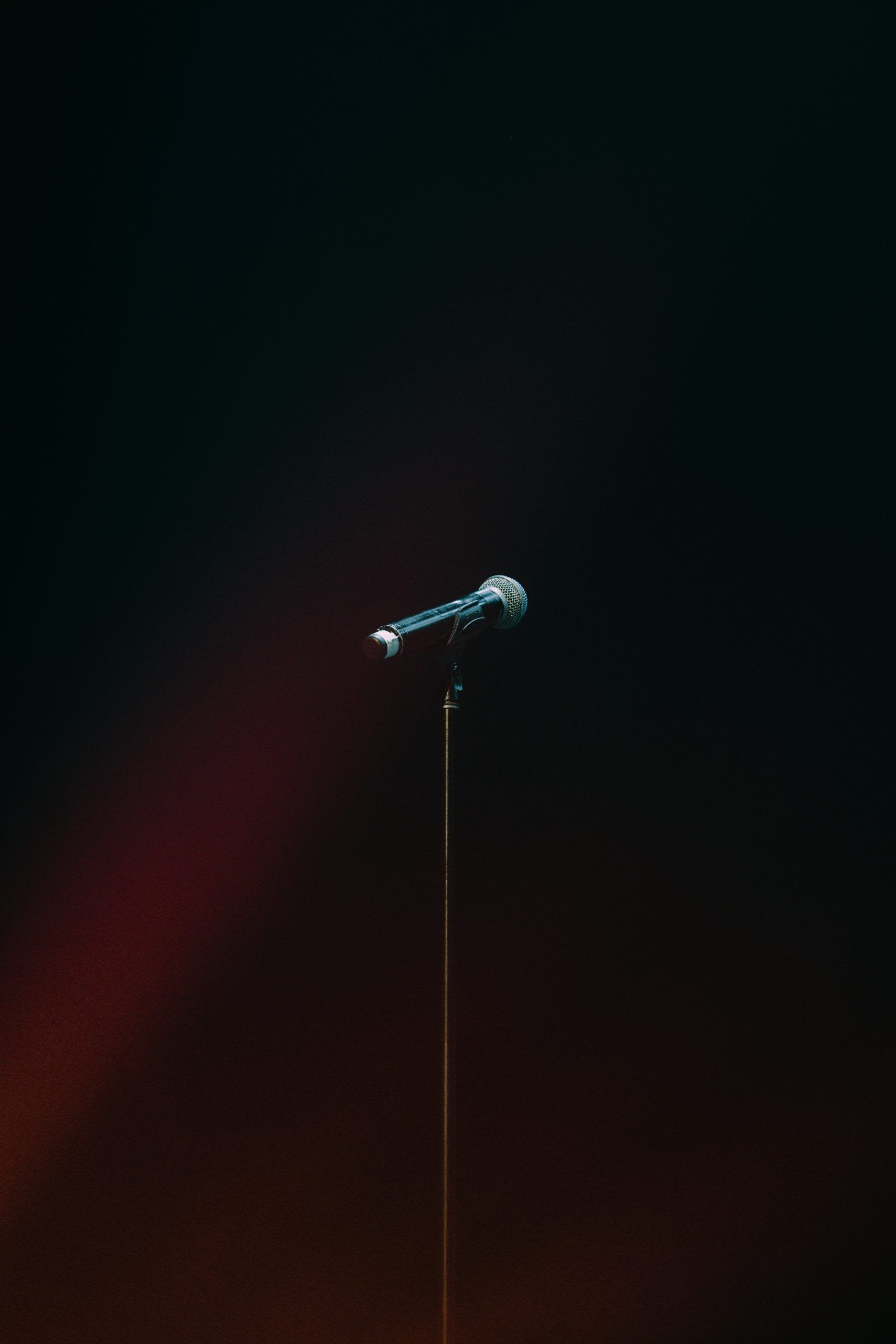 A wireless microphone in front of a dark background.