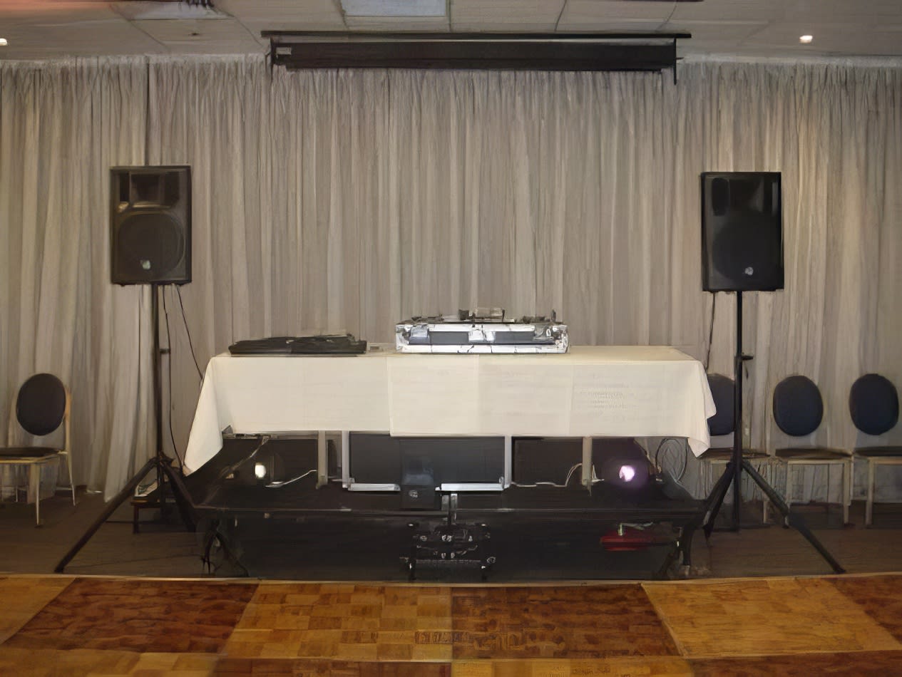 A DIY Party sound pack with a DJ set up in a room featuring speakers and speaker stands.